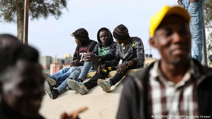 African migrant day labourers seeking small jobs, wait under a bridge in the Libyan capital Tripoli to be hired by potential employers