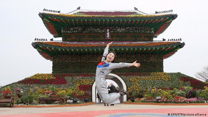 Yi So-yeon, South Korea astronaut, leaps and grins while wearing her official jumpsuit 
